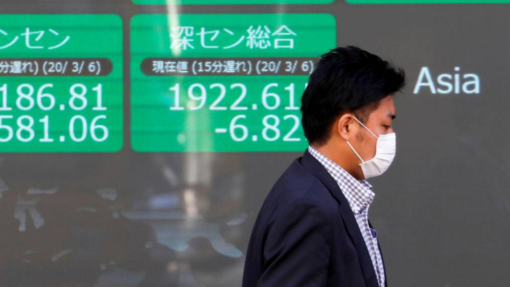 Man walks past markets sign in facemask