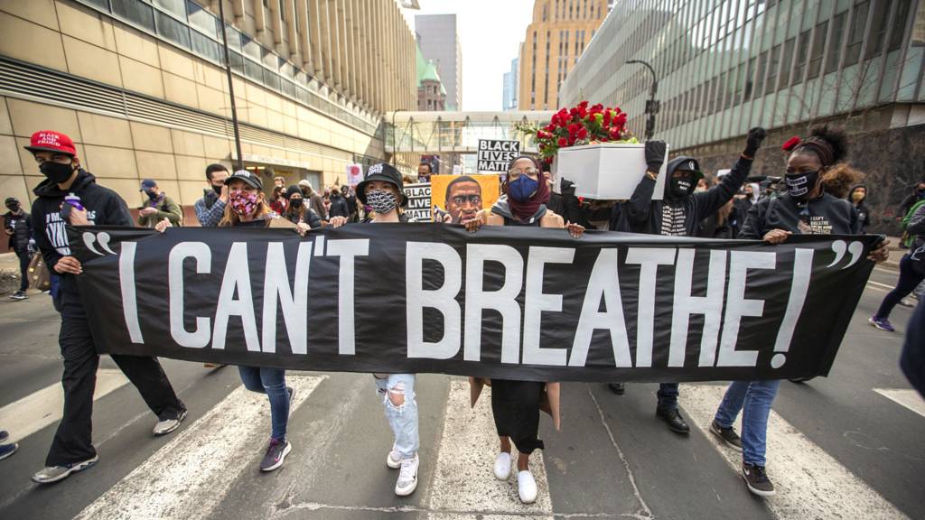 Protesters march through the city during a silent march in memory of George Floyd a day before jury selection for the trial of former Minneapolis police offices Derek Chauvin begins in Minneapolis, Minnesota, United States on March 7, 2021