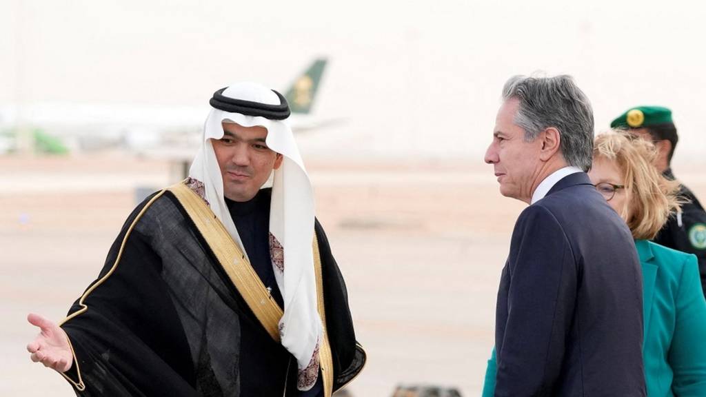Antony Blinken shakes hands with a Saudi official after landing in Riyadh