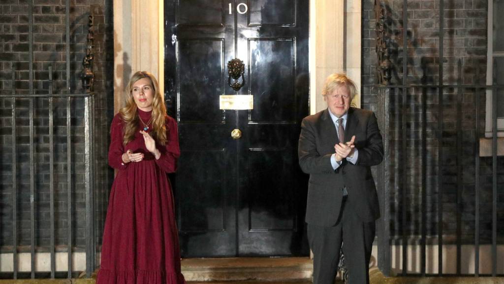 Boris Johnson and Carrie Symonds applaud outside No 10 Downing Street