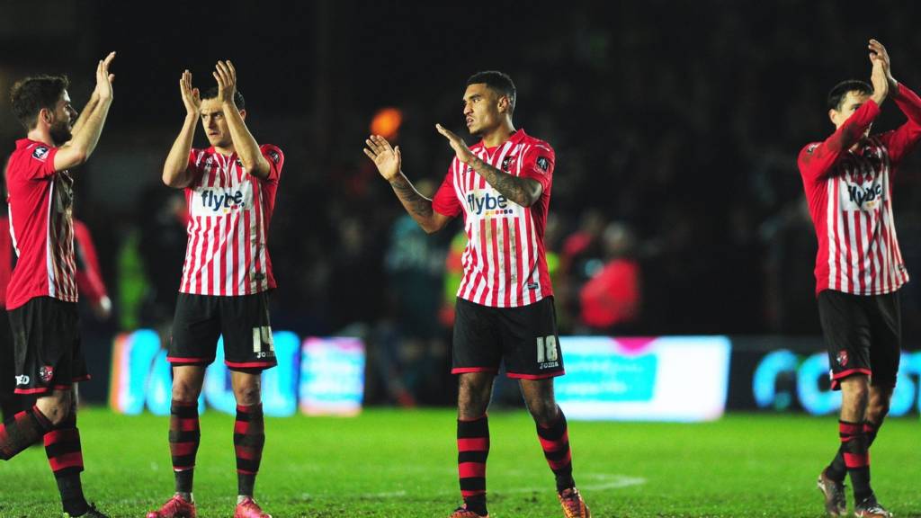 Exeter City players applaud the fans