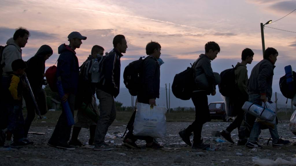 Migrants and refugees queue at a camp to be register after crossing the Macedonian-Greek border near Gevgelija on 22 September 2015.