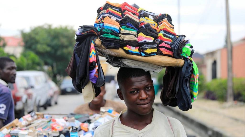 A man sells socks along a street in Lekki, Lagos, Nigeria September 12, 2017