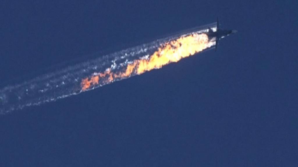 A burning trail is shown as a plane comes down after being shot down near the Turkish-Syrian border