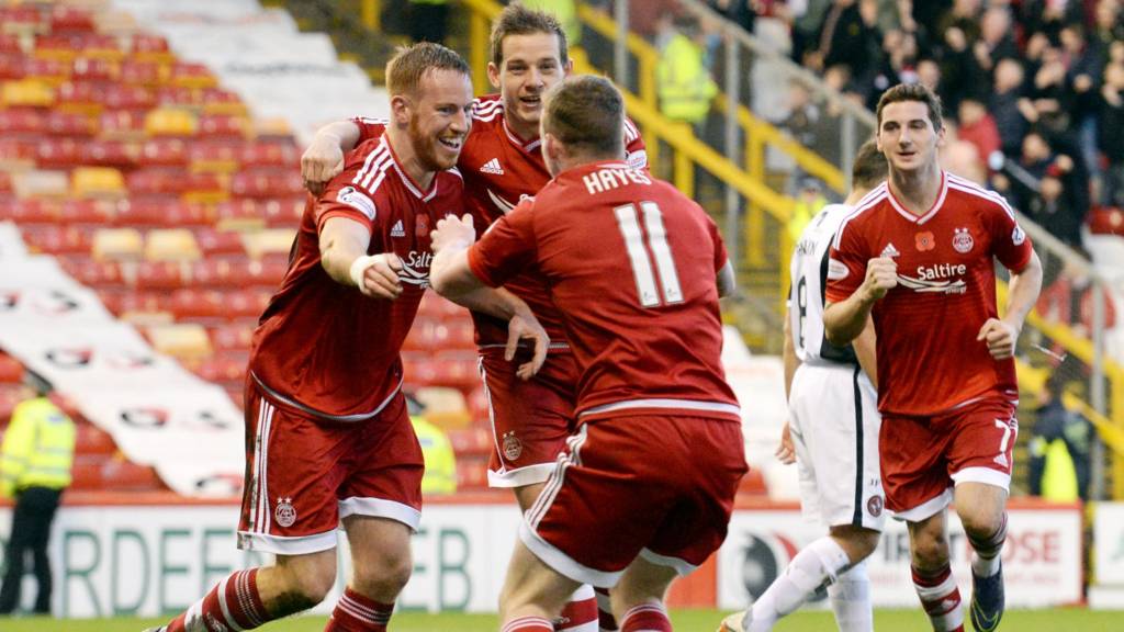 The Aberdeen players rush to congratulate Adam Rooney on his goal