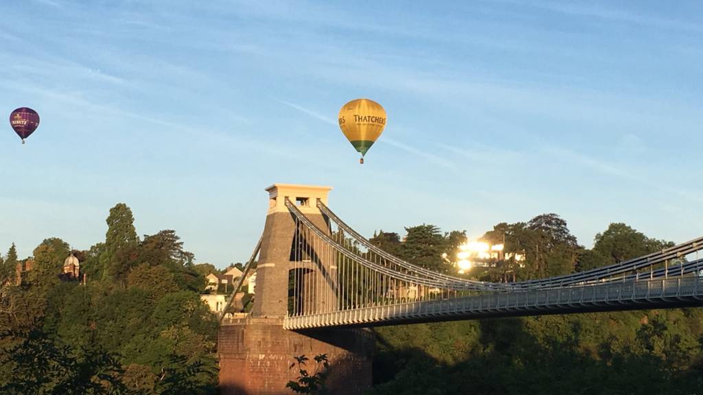 Clifton Suspension Bridge with hot air balloons flying overhead