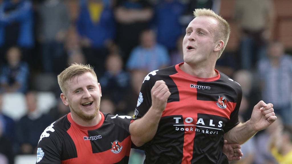 Crusaders David Cushley with goalscorer Jordan Owens