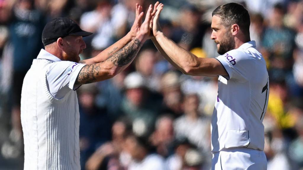 England's Ben Stokes (left) and Chris Woakes (right) high-five to celebrate a wicket