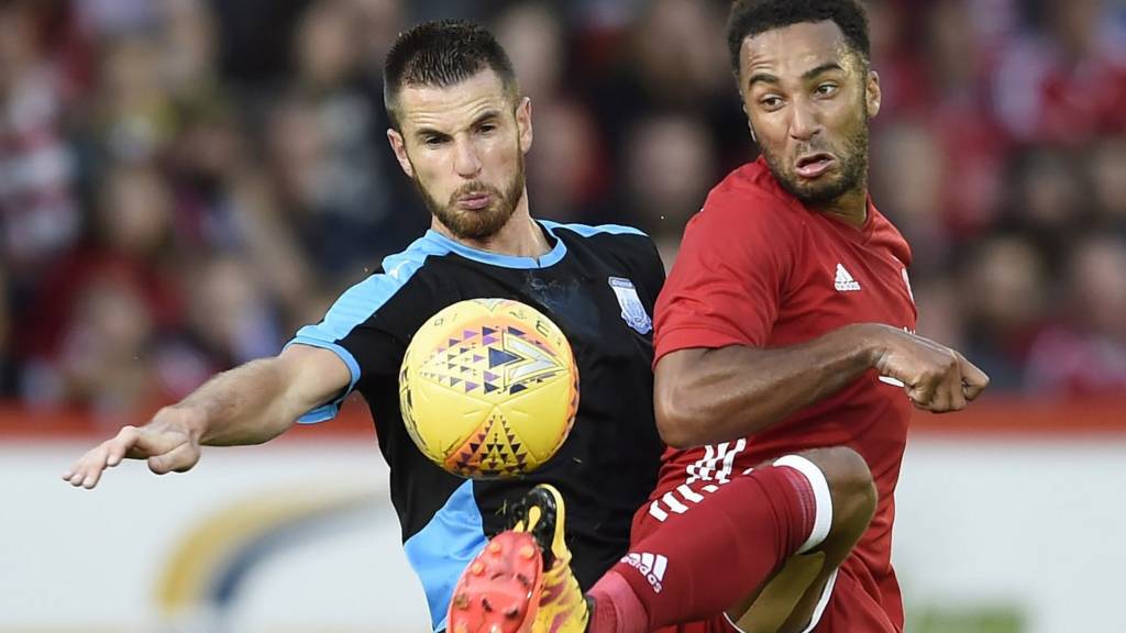 Apollon Limassol's Valentin Roberge in a challenge with Aberdeen's Nicky Maynard