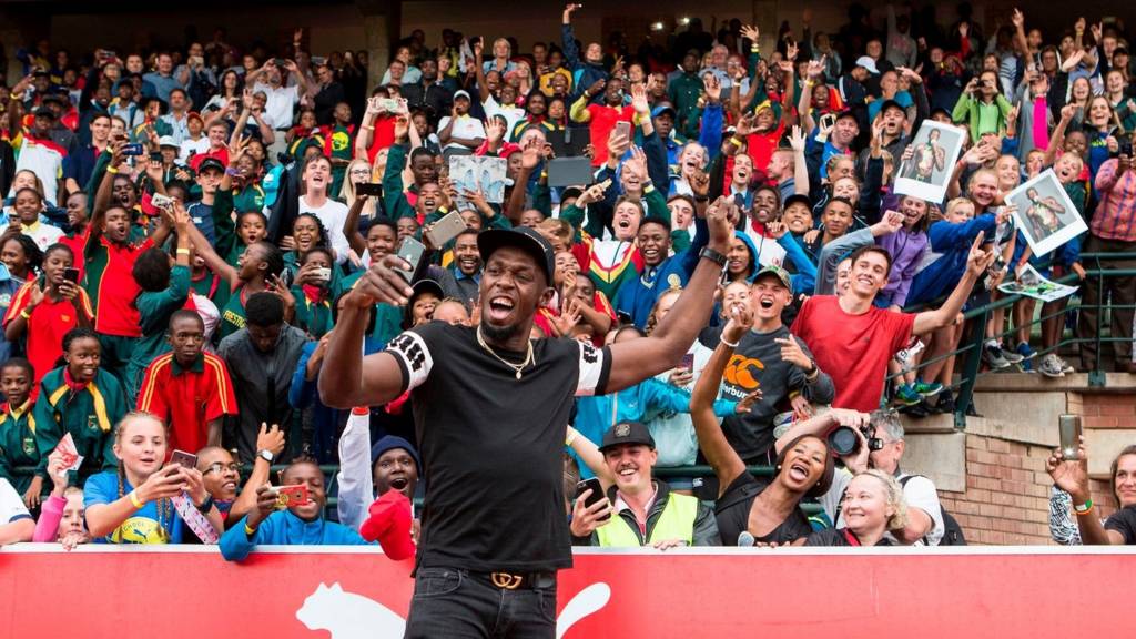 Retired Jamaican Olympic and World champion sprinter Usain Bolt poses for a selfie with spectators as he arrives for the PUMA School of Speed Athletic event at the Ruimsig Stadium in Roodepoort, Johannesburg, on January 29, 2018