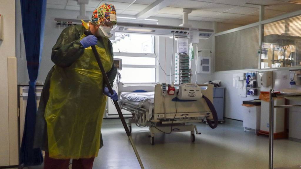 A housekeeper works on an Intensive Care ward in Frimley Park Hospital in Surrey