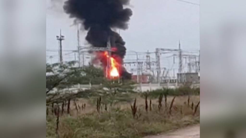 A view shows smoke rising above a transformer electric substation, which caught fire after a blast in the Dzhankoi district, Crimea