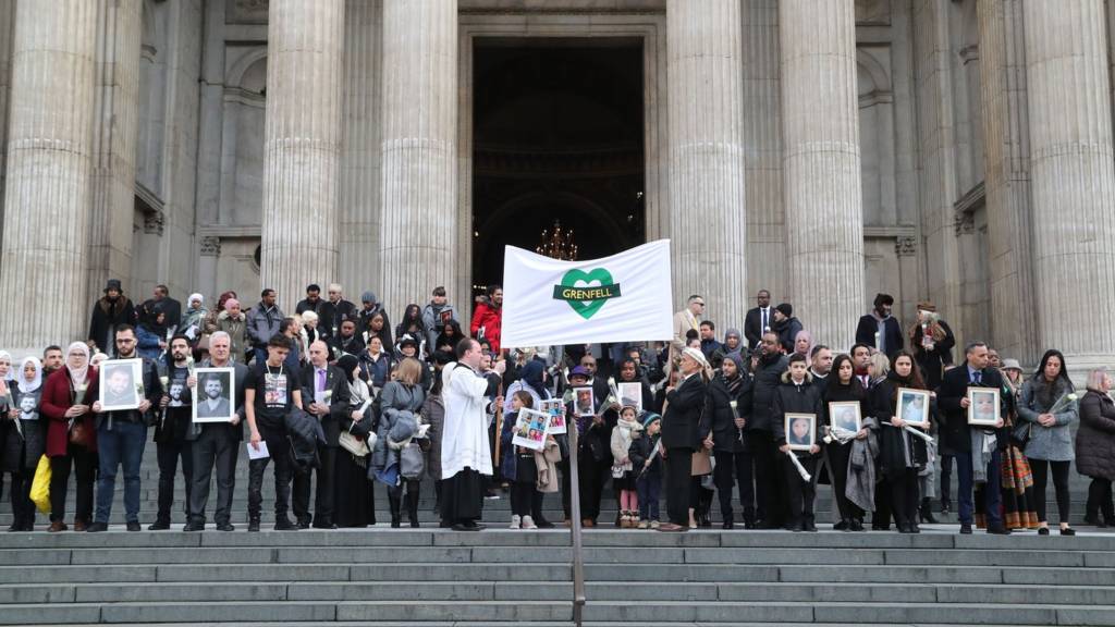 People gather on the steps after the Grenfell Tower memorial service