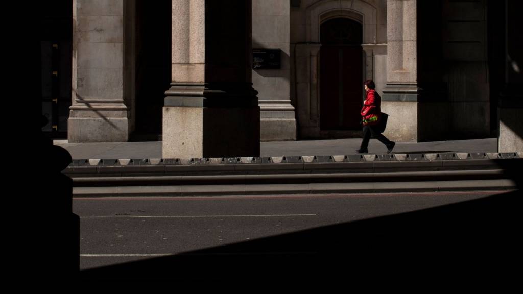 Woman walking on empty UK streets
