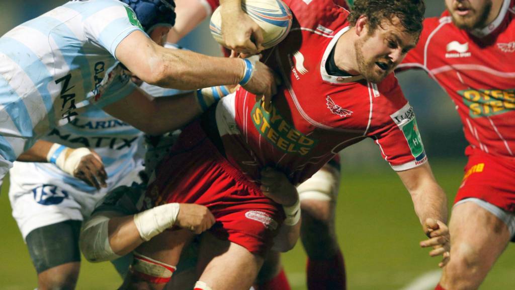 Scarlets star Johan Snyman charges through a tackle against Racing Metro