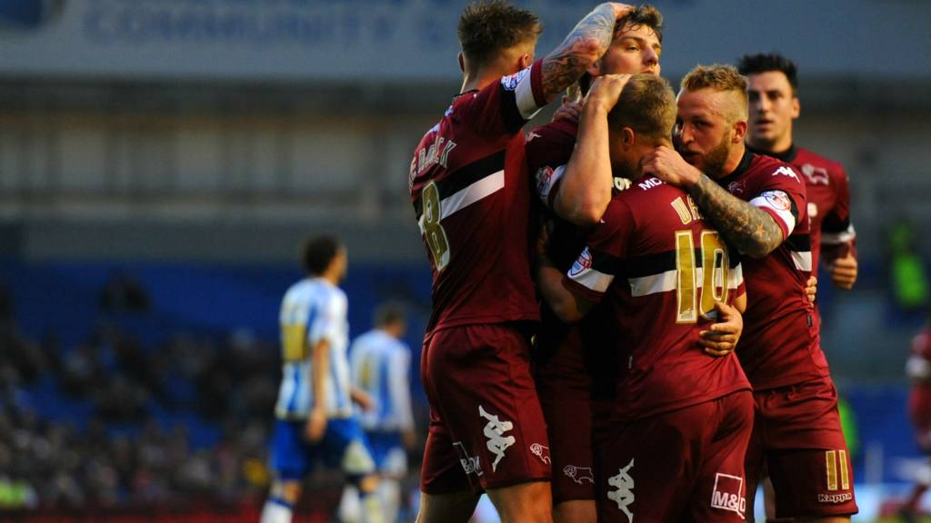 Derby players embrace after their first leg play-off win