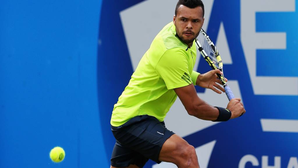 Jo-Wilfried Tsonga of France plays a backhand against David Goffin