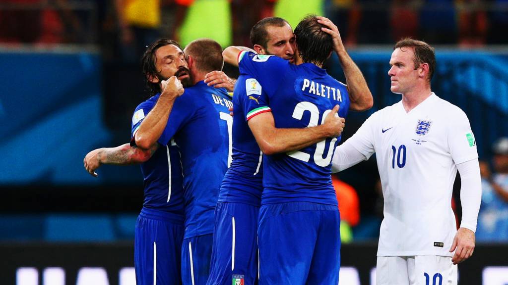 Wayne Rooney looks on as Italy celebrate their 2-1 win over England