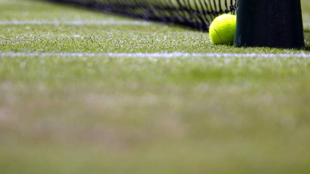 A tennis ball on one of the many grass courts at Wimbledon
