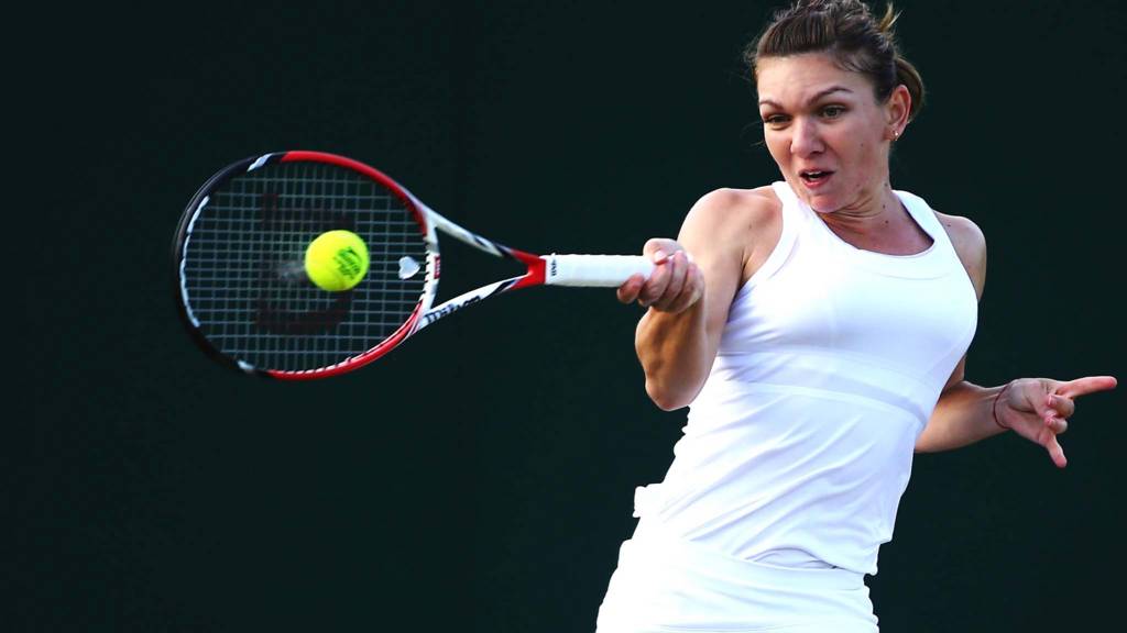 Simona Halep of Romania hits a forehand return