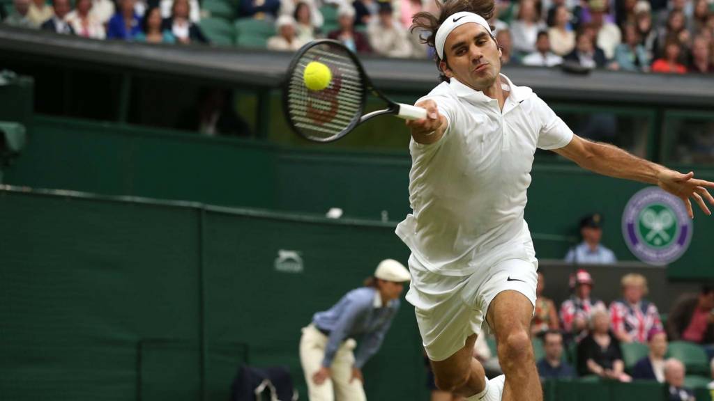 Roger Federer returns