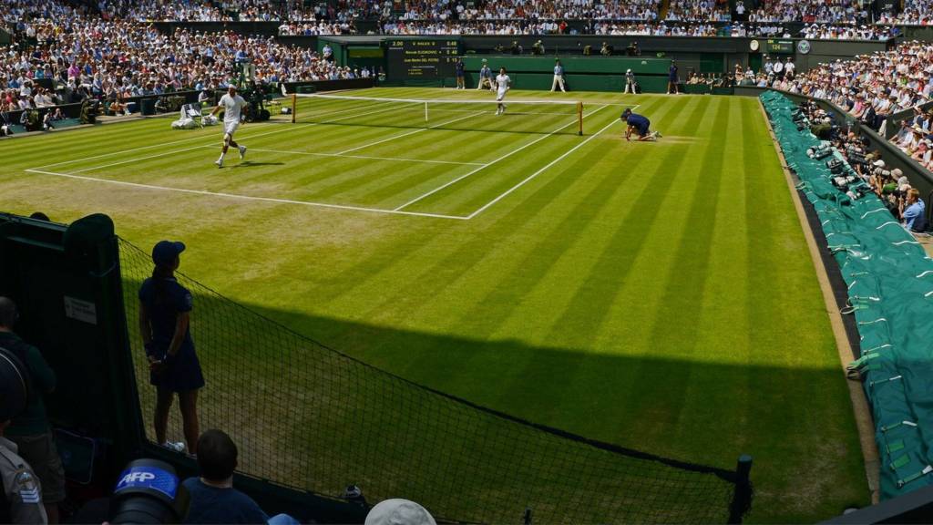 A tennis match being played on Centre Court at Wimbledon
