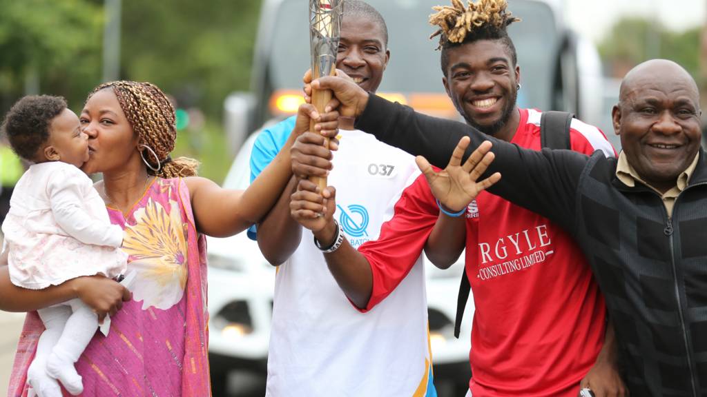 baton bearer with supporters