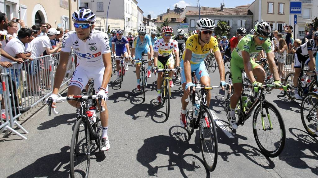 Riders ride on the streets during the 17th stage