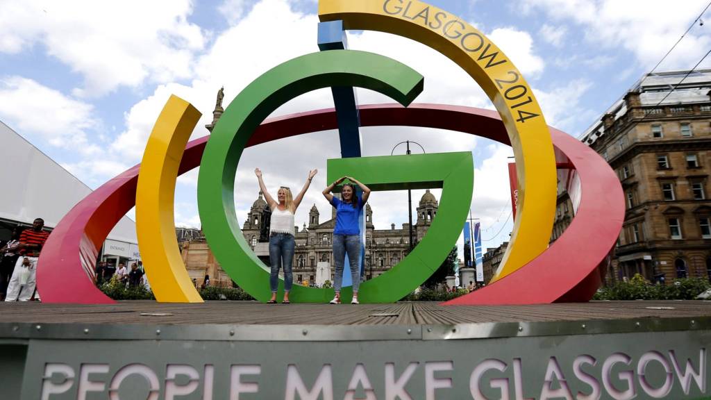 Alicia Steerand Gemma MacLean pose on "The Big G" 3-D structure at George Square in Glasgow, Scotland