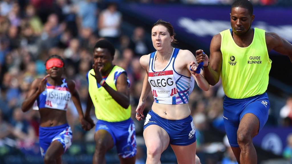 Scotland's Libby Clegg runs with her guide runner in the women"s 100m T12 at Hampden Park