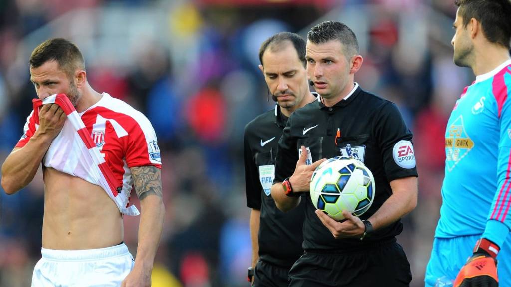 Referee Michael Oliver leaves the field