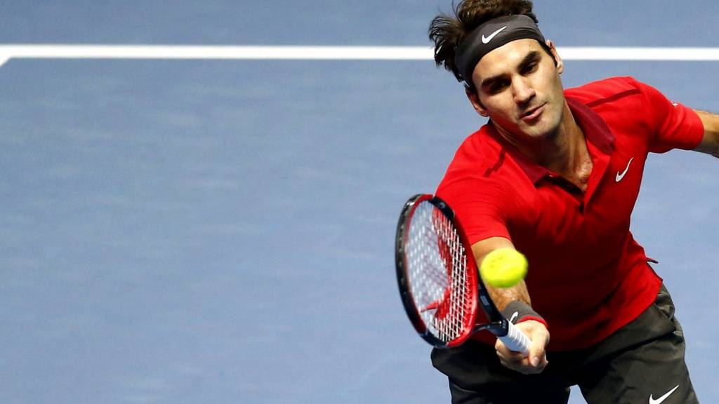 Roger Federer hits a return