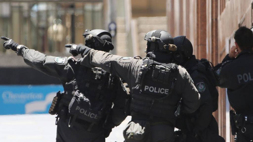 Armed police officers close to the site of a hostage situation in Sydney