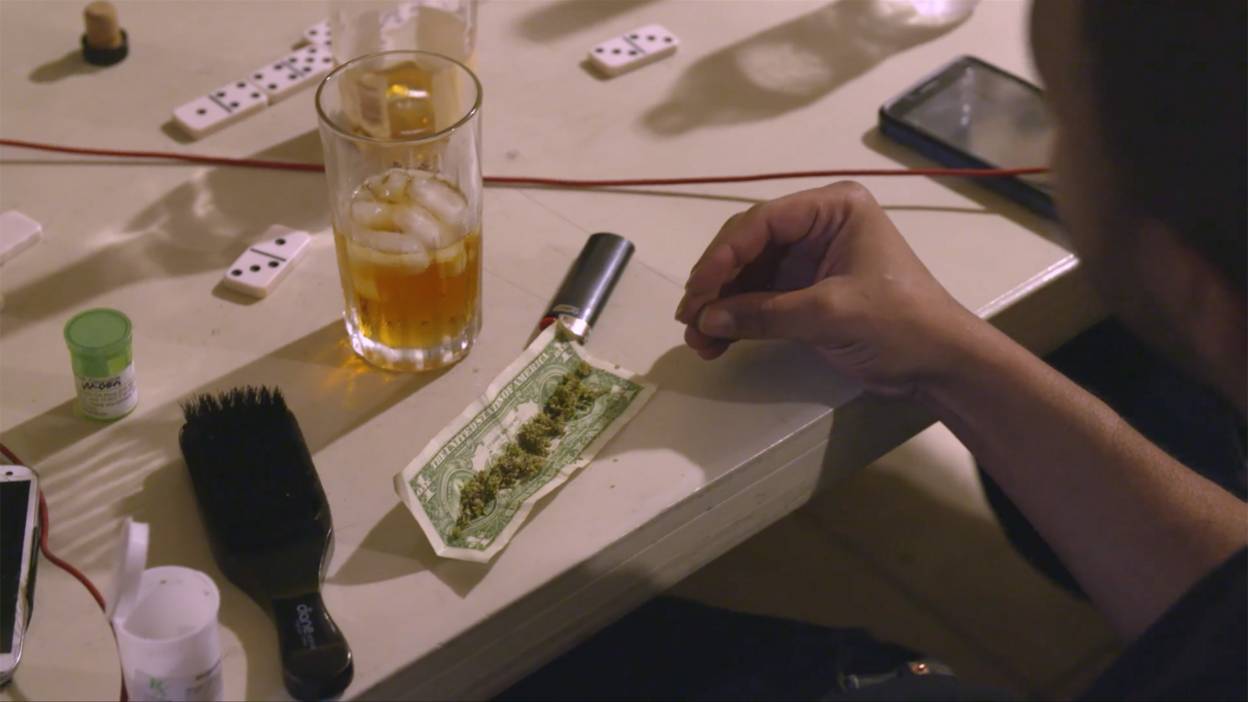 Man at table with weed and alcohol