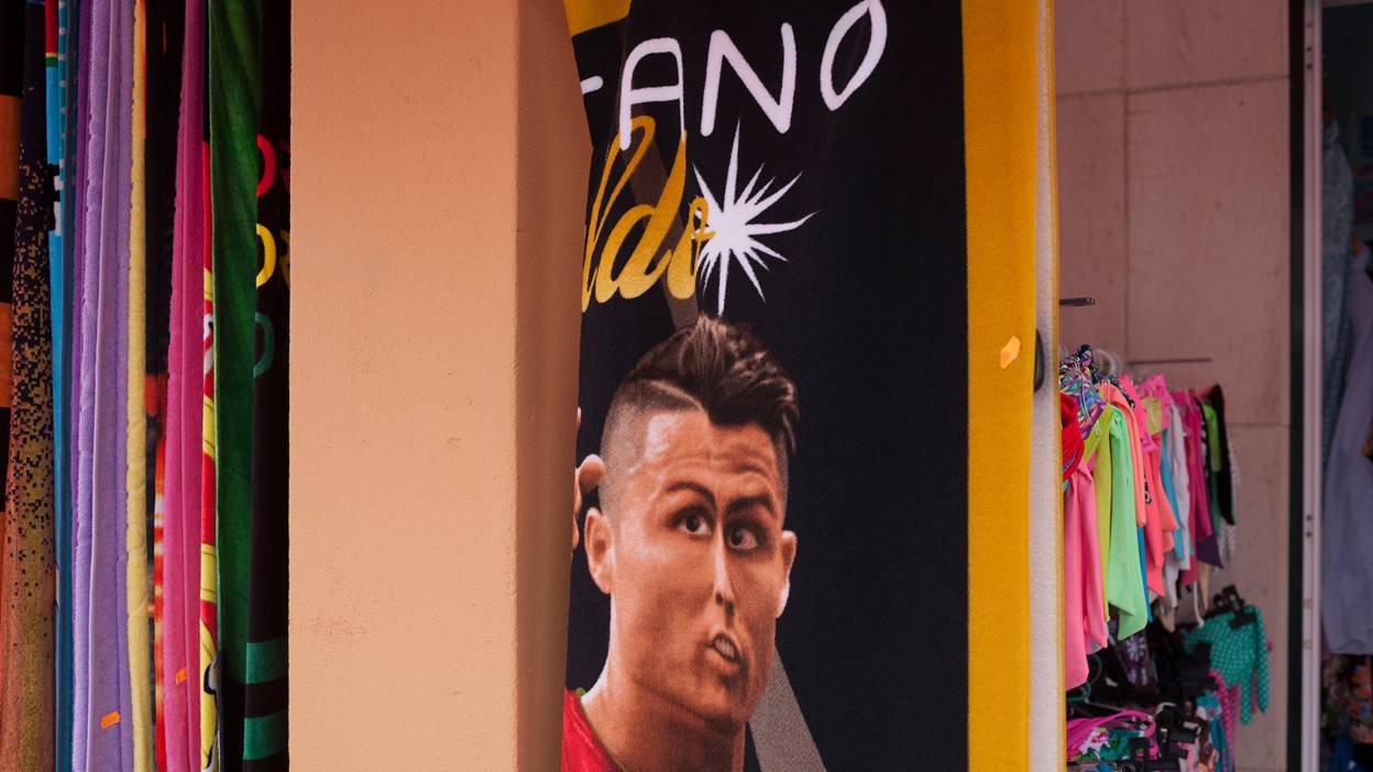 A Ronaldo beach towel hangs in a shop