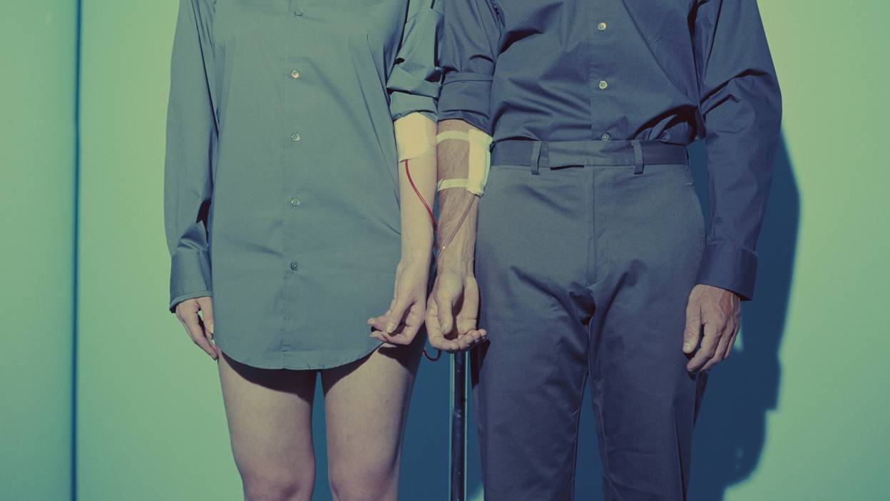 Blood transfusion, couple standing in front of blood bag.