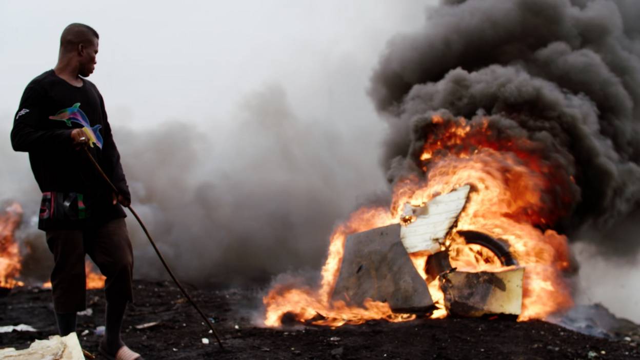 Man burning wires to retrieve copper