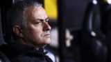 Former Manchester United manager Jose Mourinho looks out from a dugout
