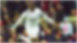 A blurred image of a footballer