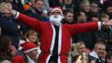Football fan dressed as Santa Claus
