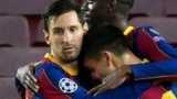 Lionel Messi (left) congratulates Pedri on scoring