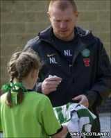 Neil Lennon signs a young Celtic fan's shirt