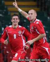 James Collins celebrates a goal versus Russia with Aaron Ramsey