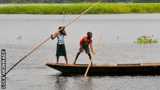 Schoolchildren paddle a canoe near Lagos
