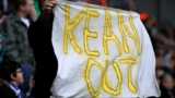 A Blackburn Rovers supporter holds aloft a "Kean Out" banner