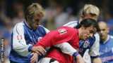 Matt Lawrence tussles with Manchester United's Ruud van Nistelrooy