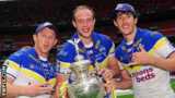 Warrington Wolves prop Chris Hill (centre) holds the Challenge Cup alongside Mickey Higham and Stefan Ratchford