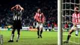 Alan Shearer looks on as Thomas Sorensen saves his spot kick