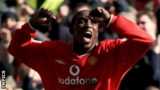 Dwight Yorke celebrates one of his three goals against Arsenal