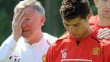 Sir Alex Ferguson puts an arm around Ronaldo in training